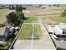 Lot bouwgrond (697 m²) + alleenstaande woning te koop Hulste